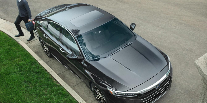 Aerial view of a black Honda Accord Hybrid parked at a curbside