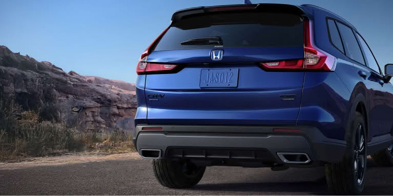 Rear overhead shot of blue CR-V driving along elevated city highway