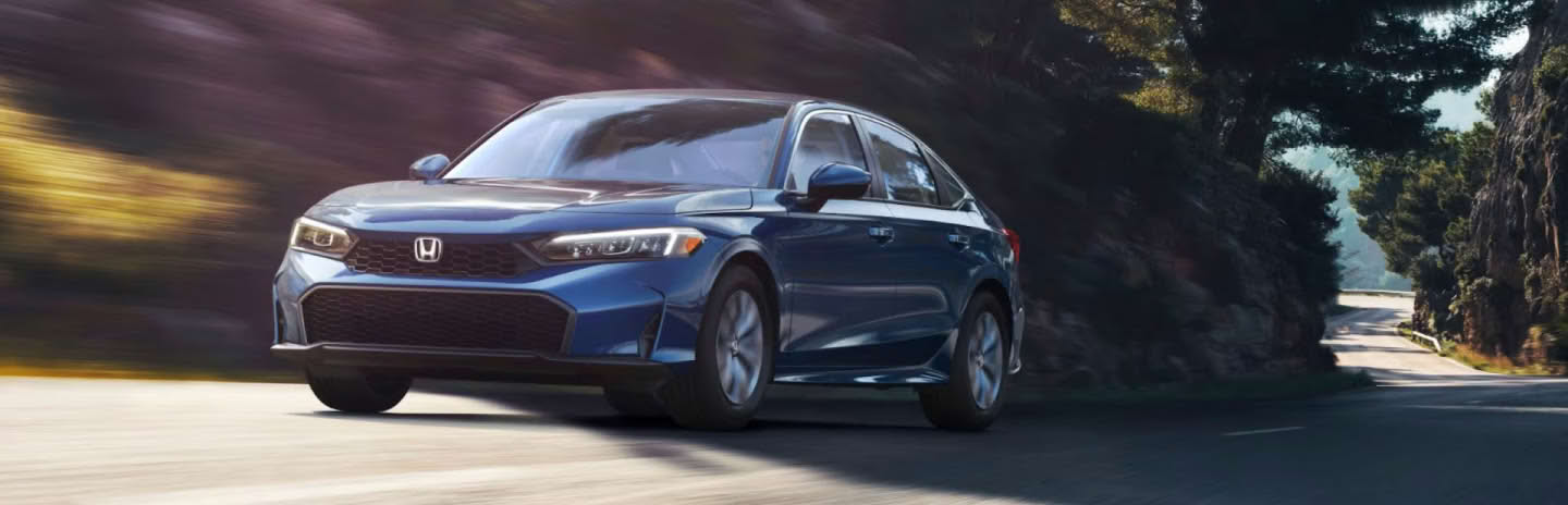 2025 Honda Civic Sedan Hybrid driving in the city