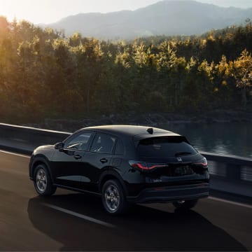 2025 Honda HR-V driving across a mountain road