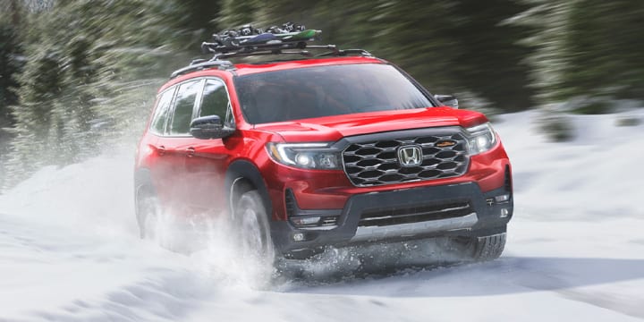 Honda Passport driving through snow