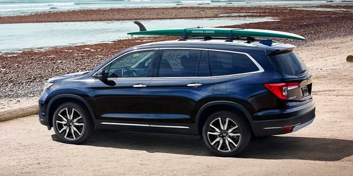 blue Honda Pilot parked at a lake