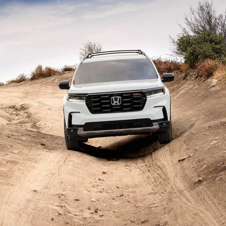 White Honda Pilot driving towards camera