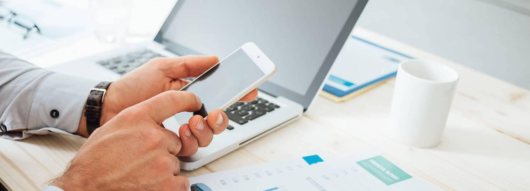 Contact us - person with phone and laptop