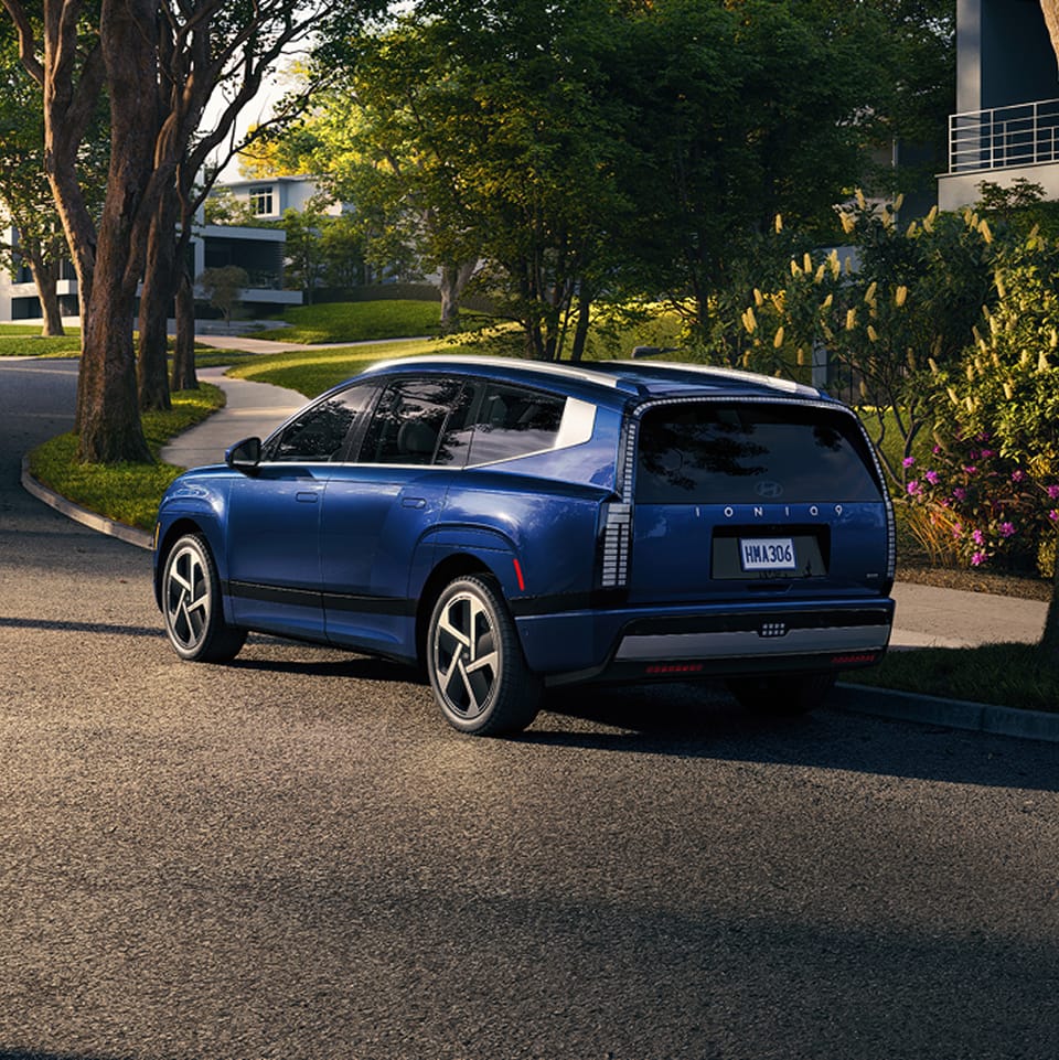 Blue Hyundai Ioniq 9 parked on residential street