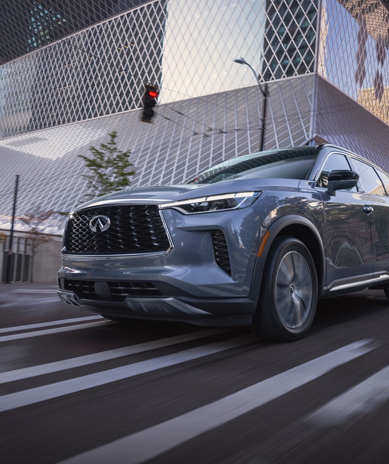 INFINITI suv driving on a city street