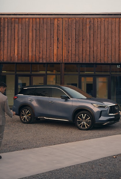 INFINITI SUV parked outside of a building