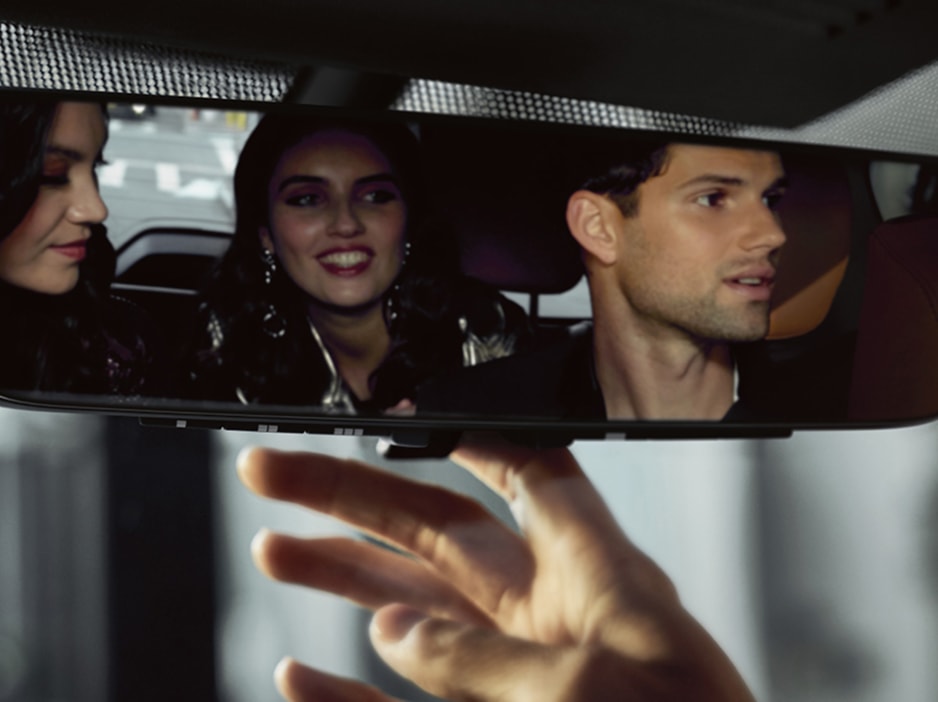 INFINITI passengers seen in the rearview mirror