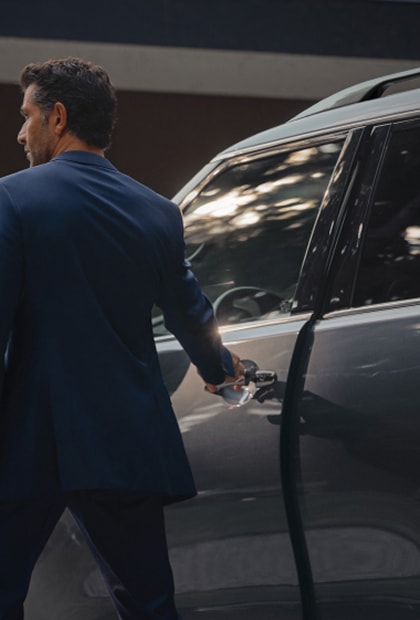 Owner opening the door of an INFINITI SUV