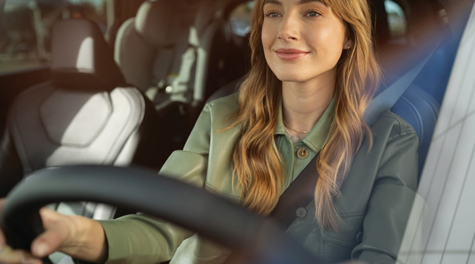 Interior view of an owner behind the wheel of an INFINITI