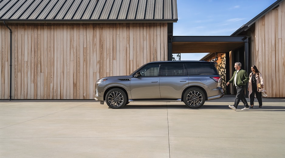 INFINITI SUV parked in front of a wood sided building