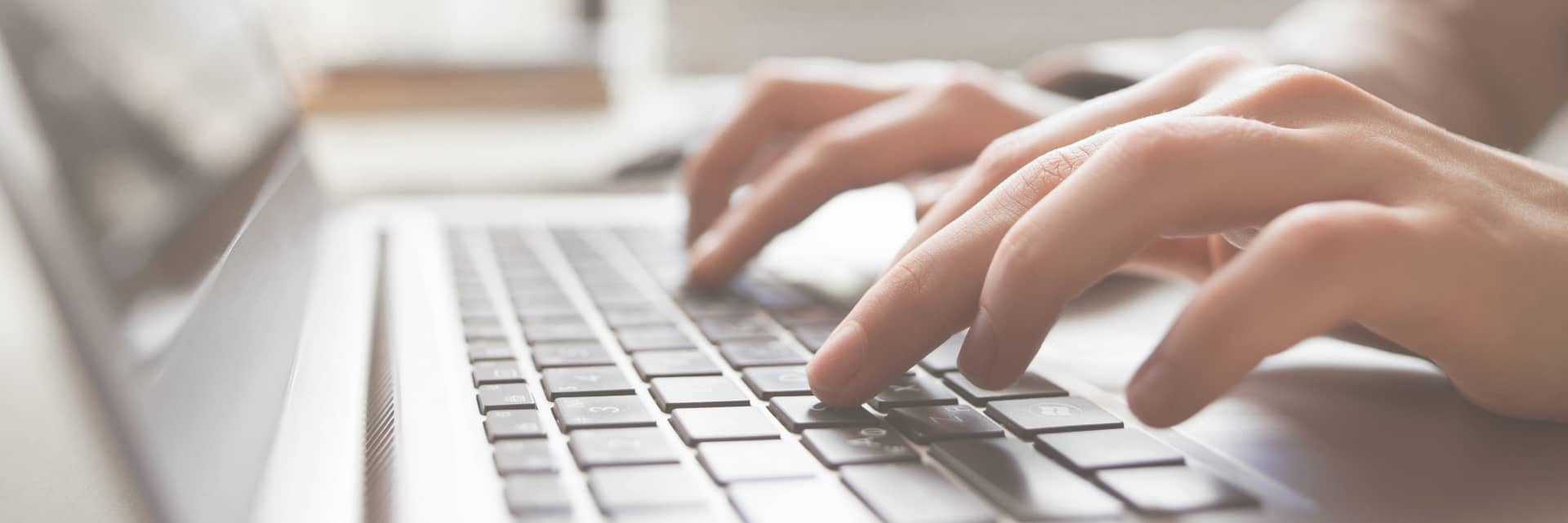 person typing on laptop keyboard