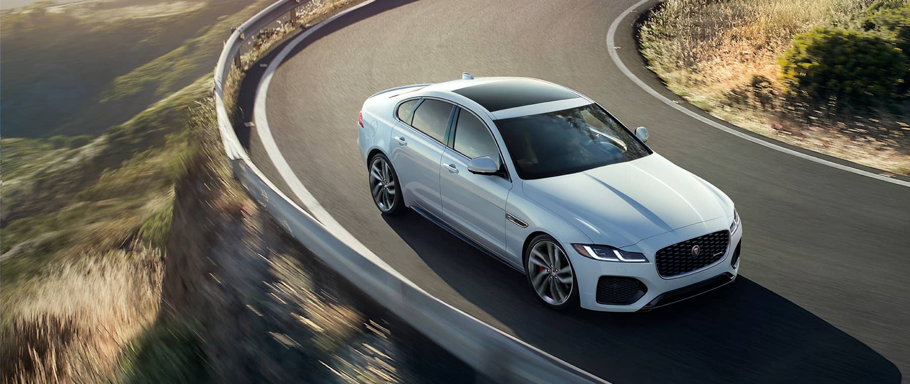 Jaguar vehicle driving around a curved road