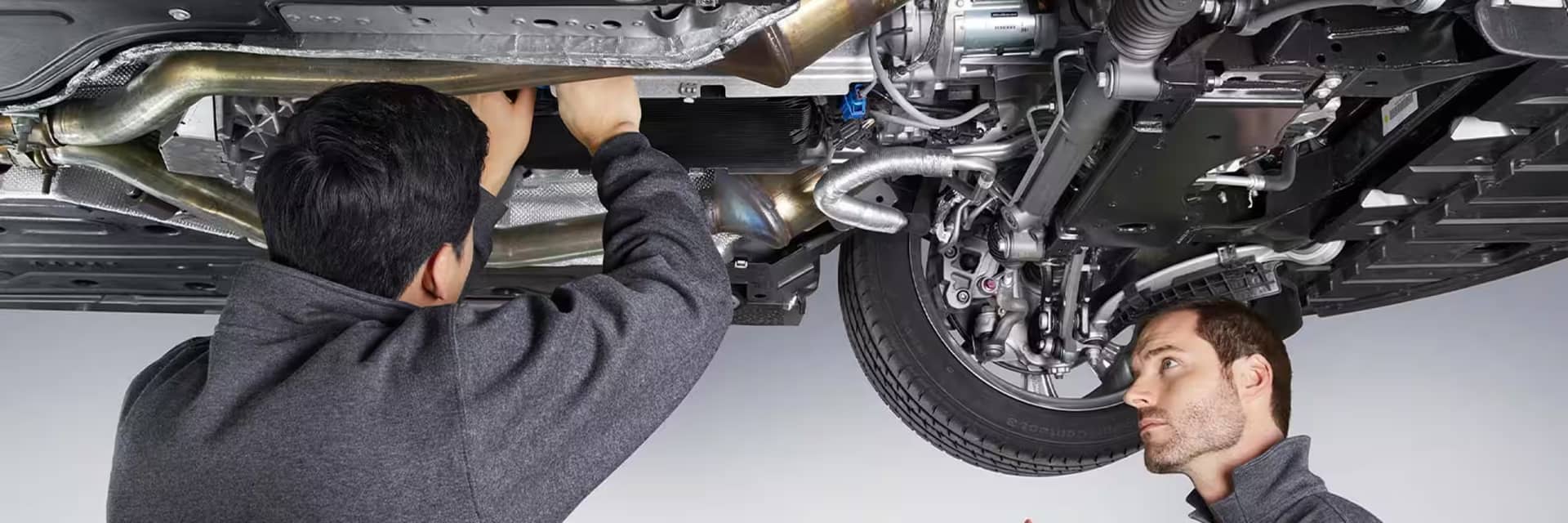 Jaguar service mechanic working on vehicle