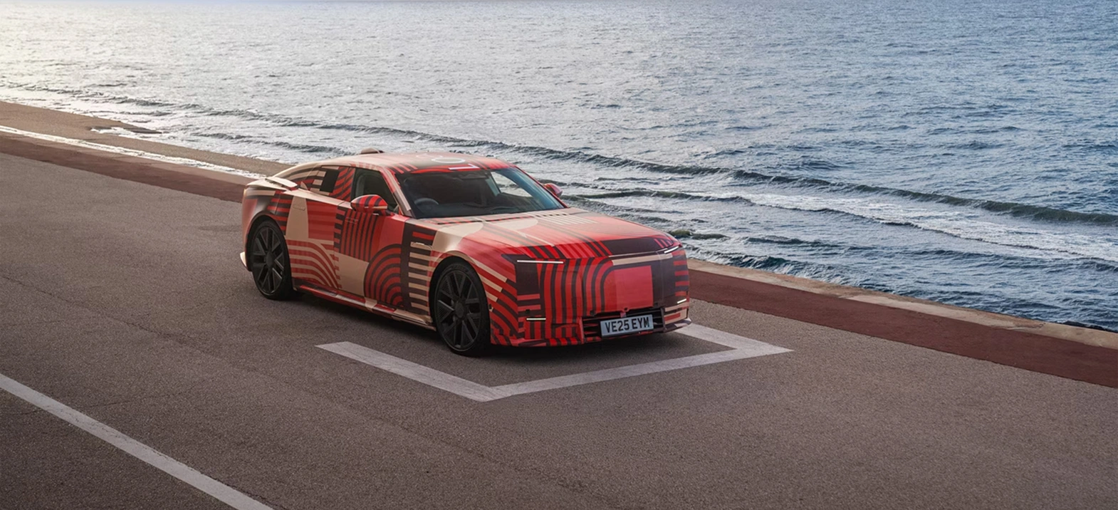 Jaguar Type 01 sitting on a road next to a body of water