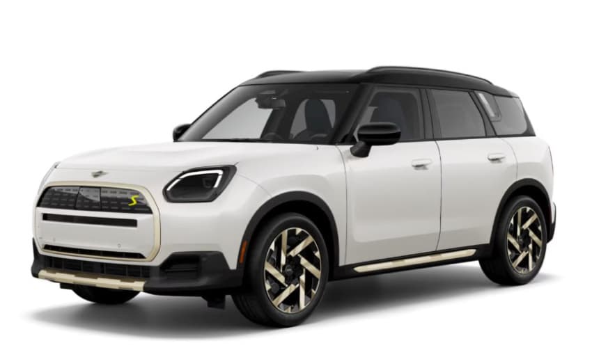 Angled view of a white MINI Countryman SE ALL4 vehicle parked.