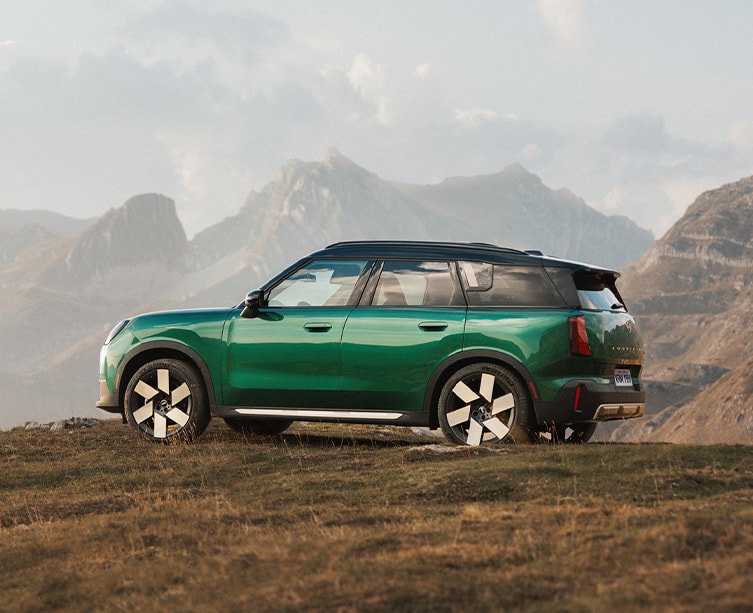 Side profile shot of British racing green MINI Countryman.
