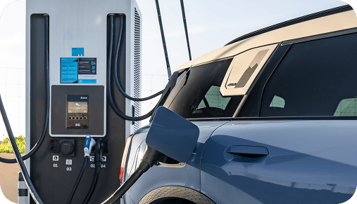 A MINI Countryman SE ALL4 charging at a charging station.