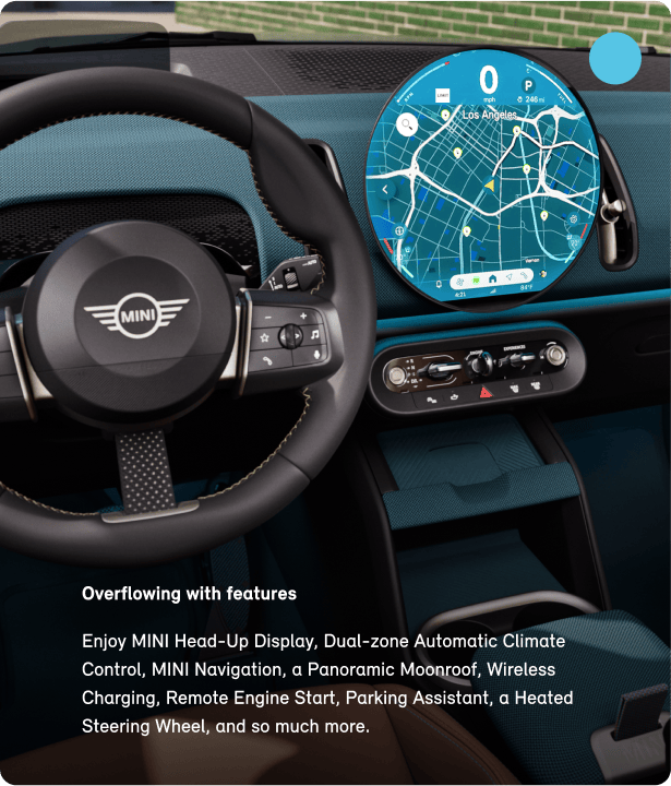 The interior of the MINI Countryman S ALL4 with a focus on the steering wheel and display.