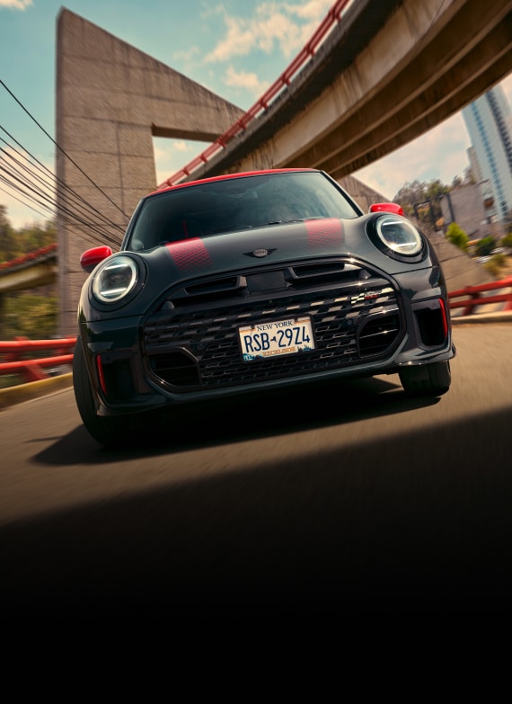 Low-angle, front view of a MINI JCW 2 Door while driving.  