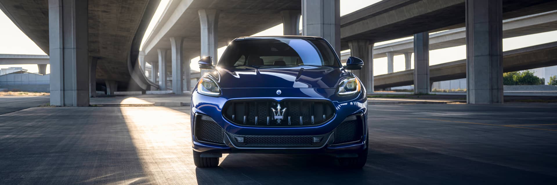 Front view of a blue 2023 Maserati Grecale parked under a bridge