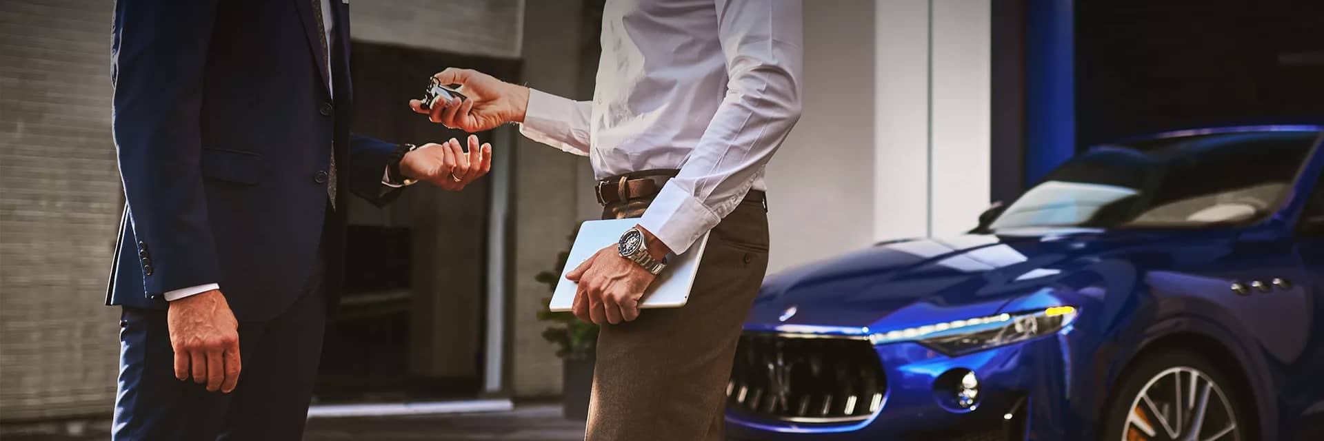 A man handing over keys for Maserati service