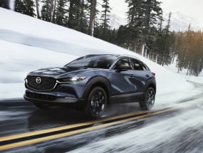 2022 Mazda CX-30 going swiftly down a snowy street