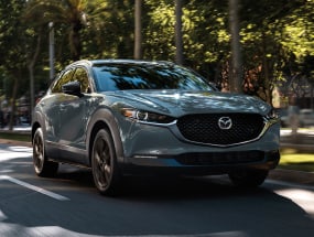 2022 Mazda CX-30 going smoothly down a wooded street