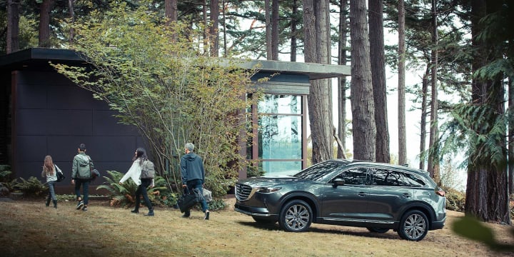 2022 Mazda CX-9 Signature parked in a wooded front yard