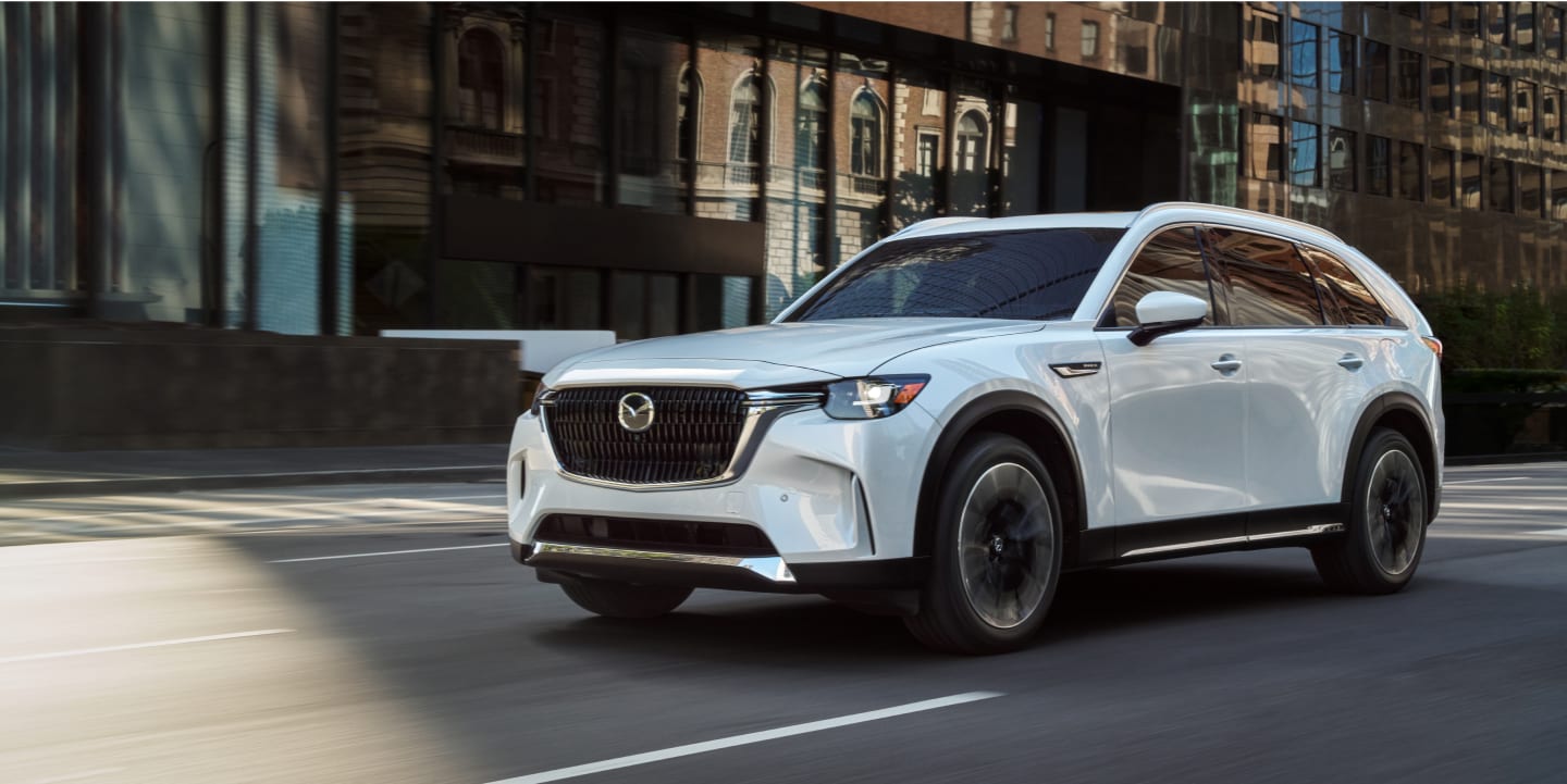 Mazda CX-90 PHEV driving on a city street
