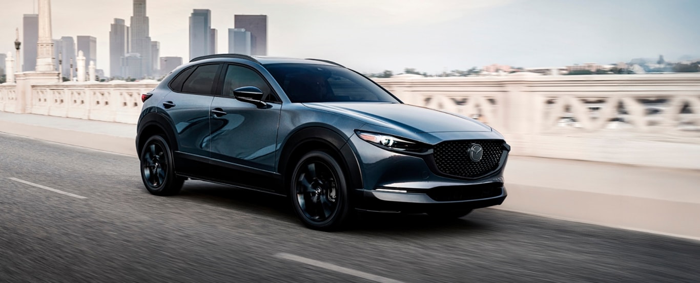 2025 CX-30 driving on a city bridge