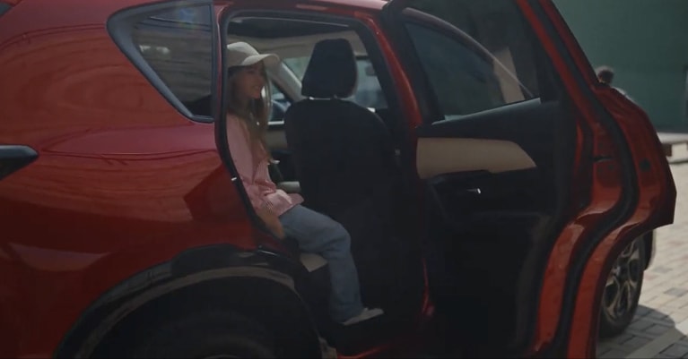 child exiting the back seat of a CX-5
