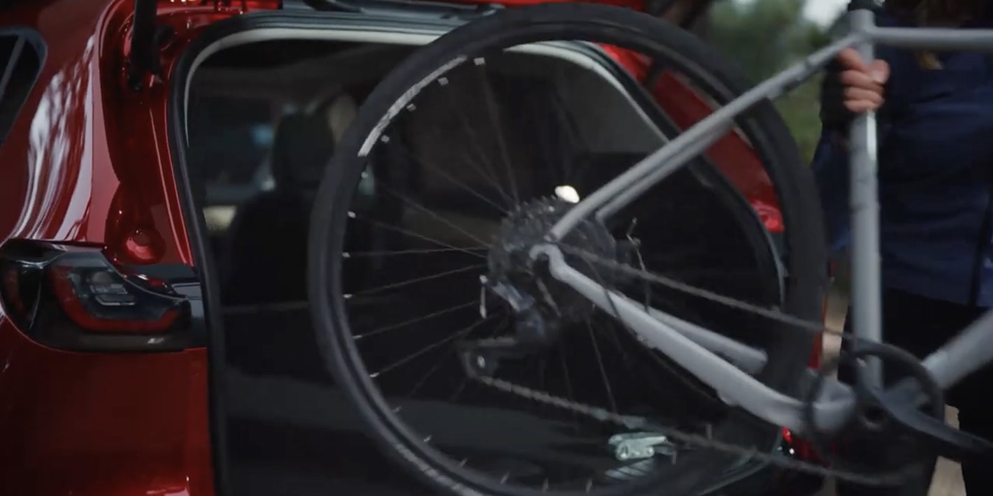 CX-5 owner pulling a bike out of the rear hatch