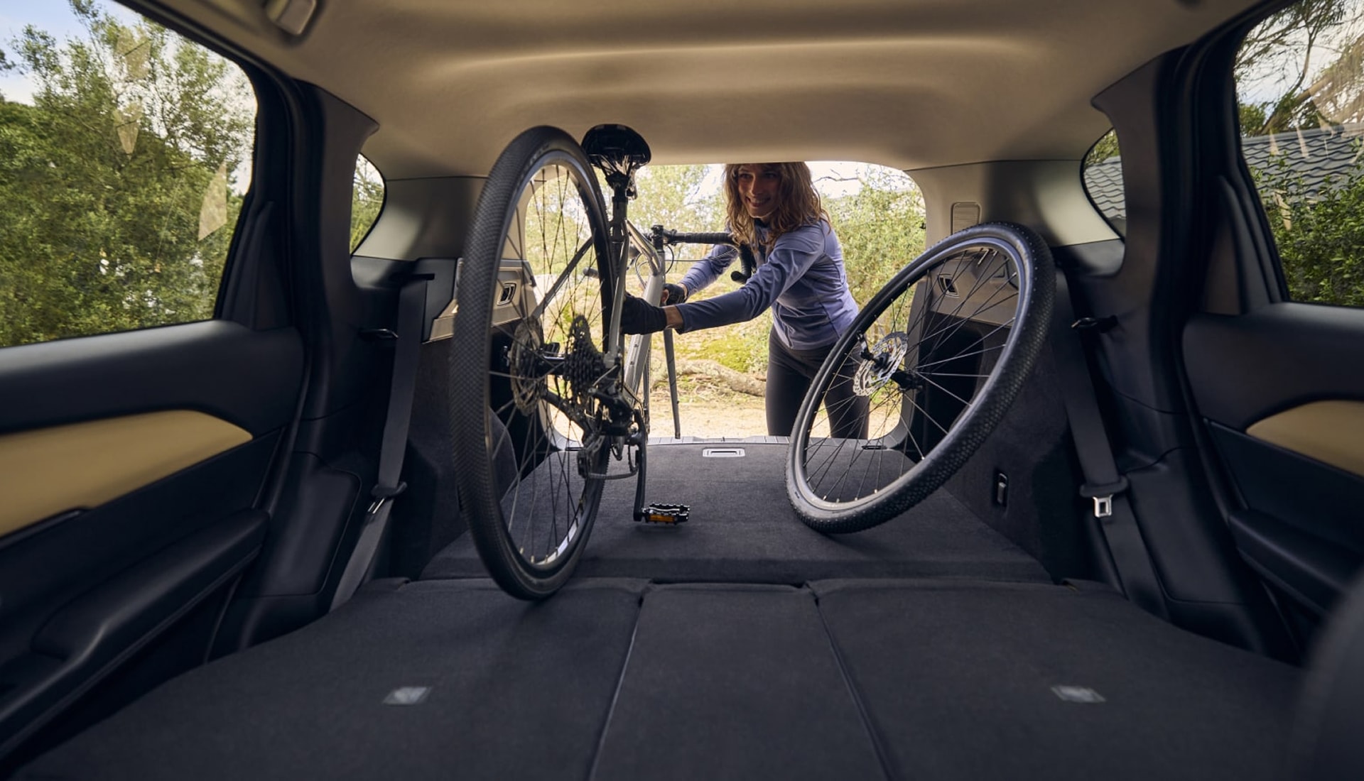 driver loading a bike into the rear of a 2026 CX-5 