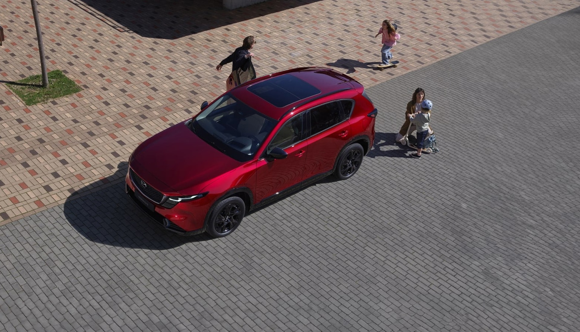 overhead view of a family near a 2026 CX-5 