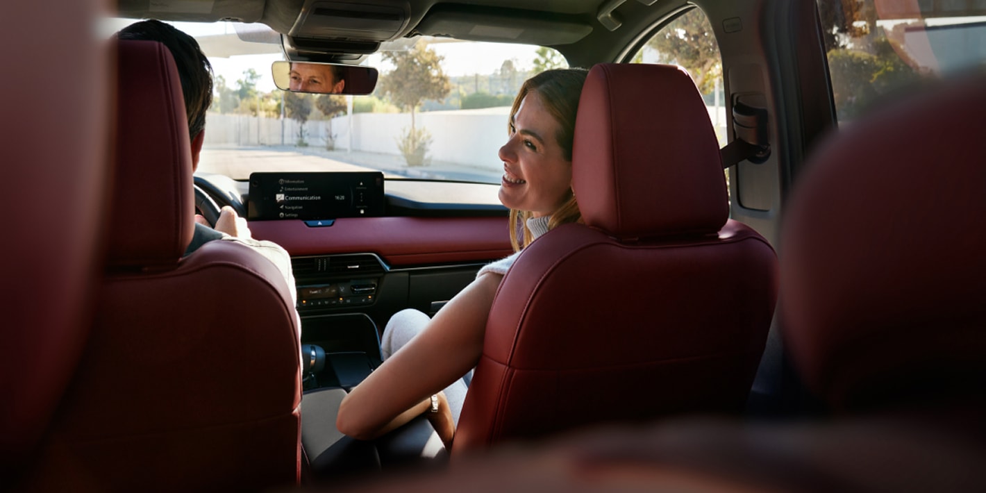 passenger smiling at the driver of a CX-70