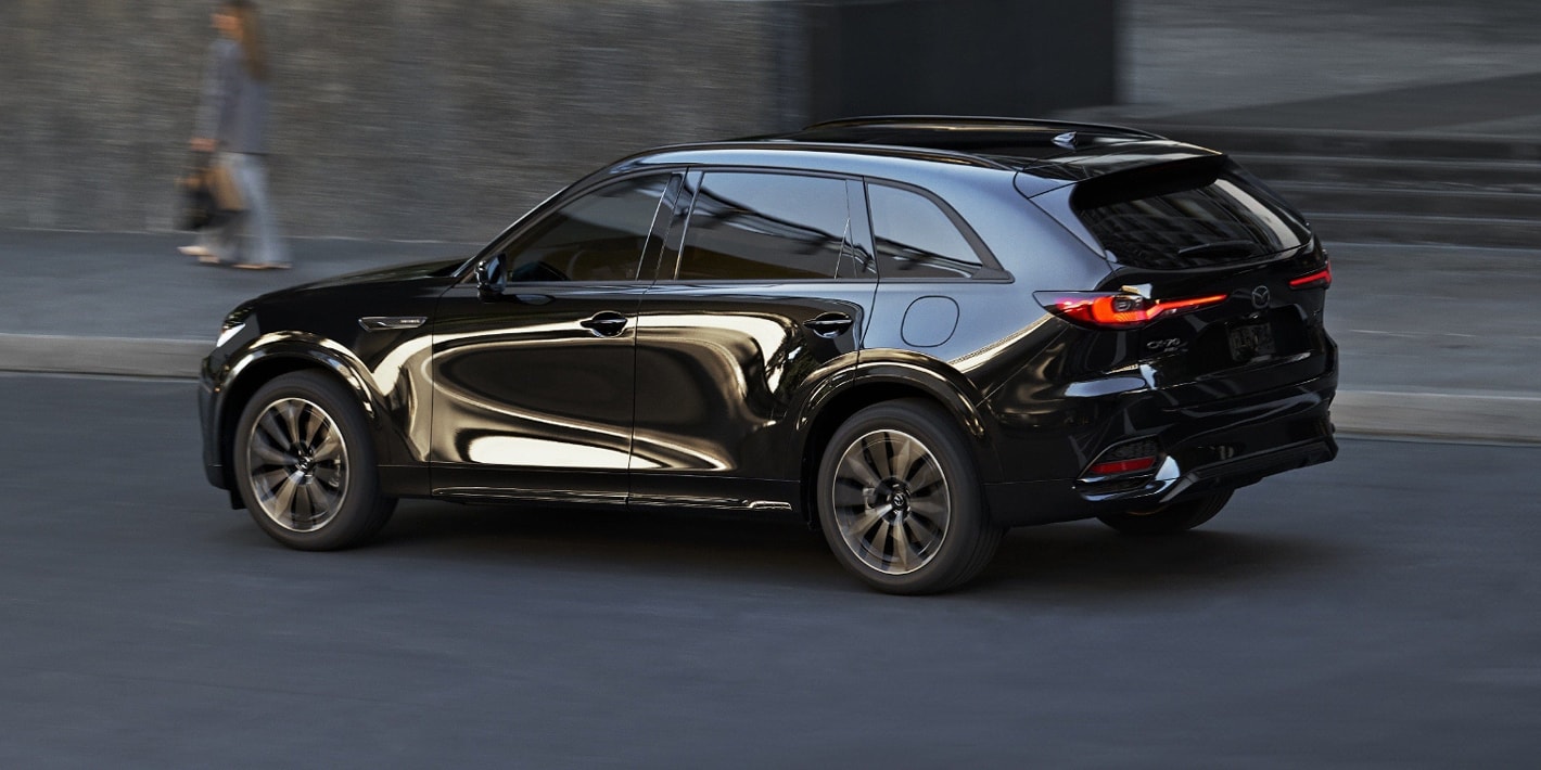 Black Mazda CX-70 driving in the city
