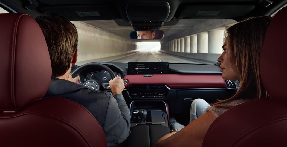 rear seat view of a couple driving a CX-70