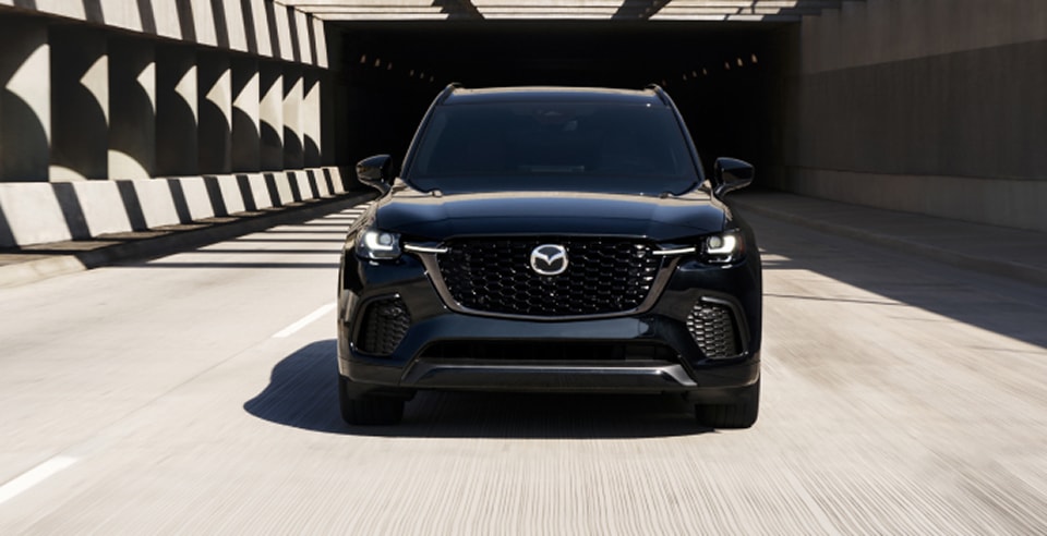 black CX-70 driving out of a tunnel