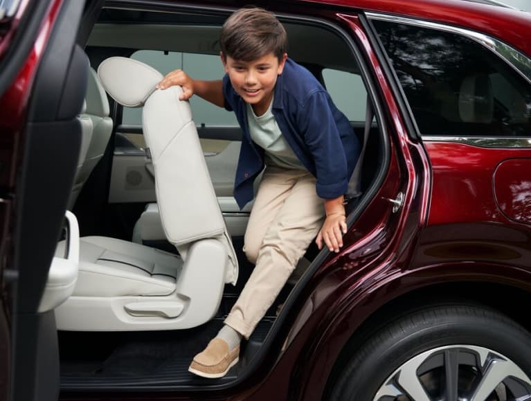 Child climbing out of a Mazda CX-90 