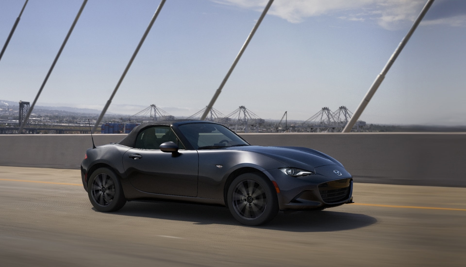 2026 Mazda MX-5 Miata driving on a suspension bridge
