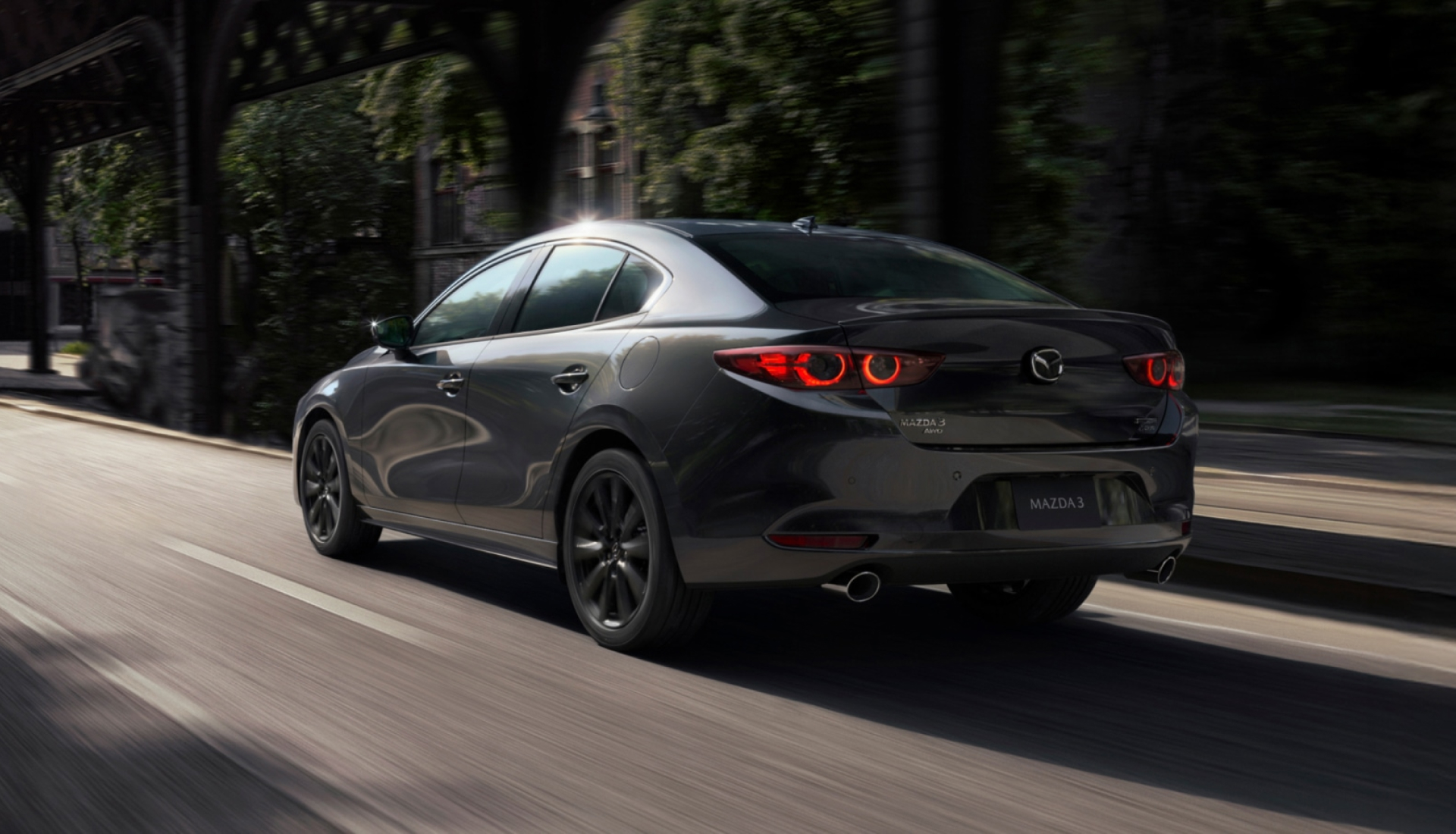 2026 Mazda3 Sedan driving on an urban road