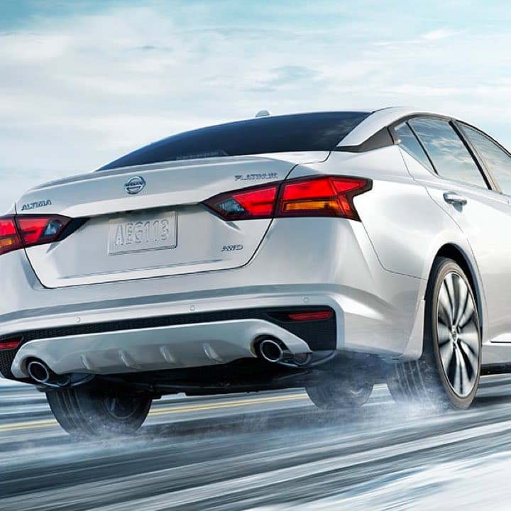 Rear view of nissan driving