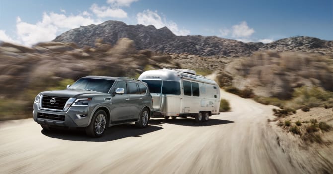 2023 Nissan Armada towing a camper through desert mountains