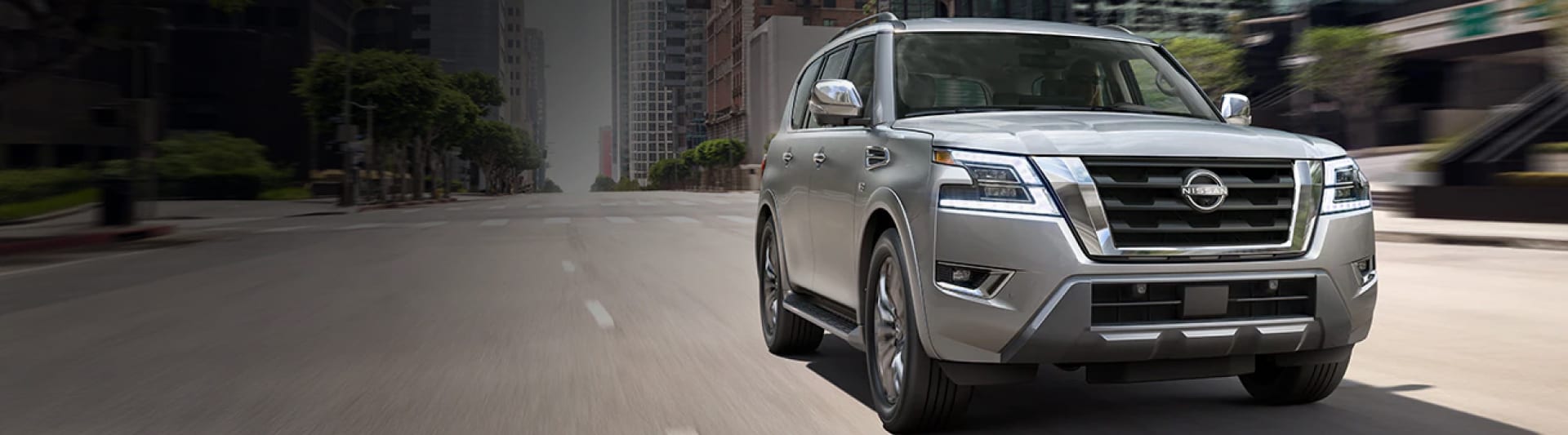 SIlver 2023 Nissan Armada driving on a city street