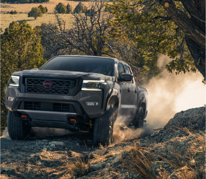 2023 Nissan Frontier driving on a dirt road