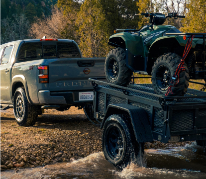2023 Nissan Frontier towing an ATV