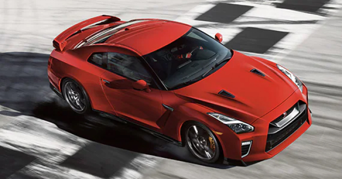 Red 2023 Nissan GT-R driving on a race track
