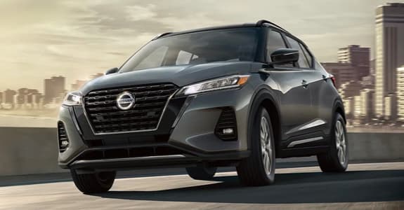 Grey Nissan Kicks driving