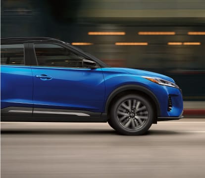 Side view of Versa Kicks driving on city street